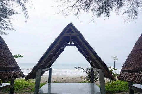Three triangular gazebos roofed with palm leaves, photo from the front Stock Photos