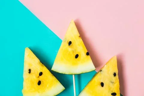 Three triangular ice cream slices on a stick of ripe yellow watermelon 写真素材