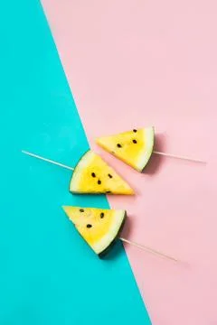 Three triangular ice cream slices on a stick of ripe yellow watermelon 写真素材