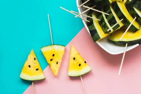 Three triangular ice cream slices on a stick of ripe yellow watermelon 写真素材