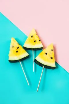 Three triangular ice cream slices on a stick of ripe yellow watermelon 写真素材