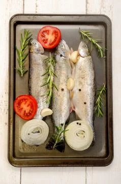 Three trout in a roasting tin Stock Photos