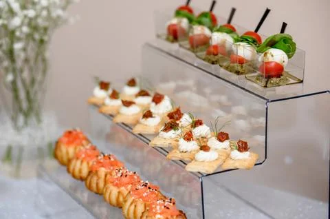 Three types of appetizers on a transparent stand including caprese Stock Photos