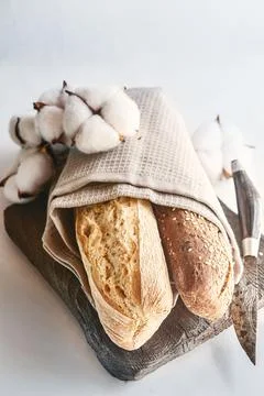 Three types of bread are lying in a napkin on the table Stock Photos