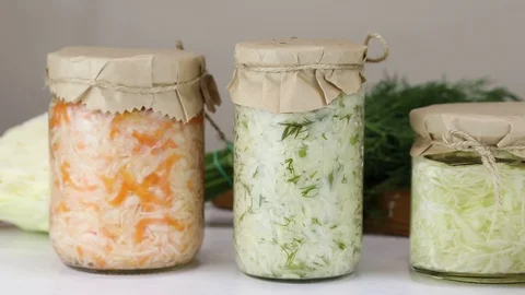 Three types of fermented cabbage in glass jars Stock Footage 121809213