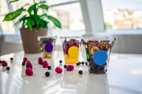 Three types of fruit and berry smoothies in glasses. Nuts and raspberries Stock Photos