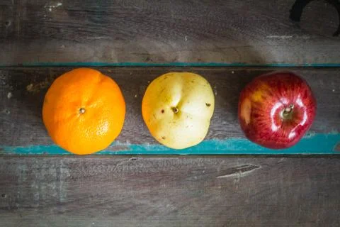Three types of fruit  on a wooden. Stock Photos