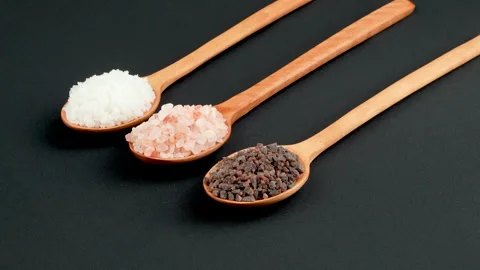Three Types Gourmet Salt Rotating On Wooden Spoons Black Video stock 331852035