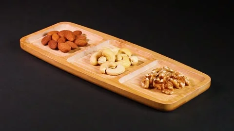 Three types of nuts on a tray, rotating Stock Footage 313413418