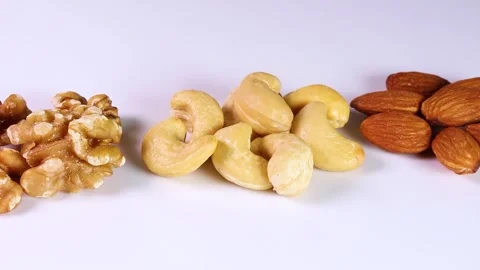 Three types of nuts on white background, rotating Stock-Footage 313413457
