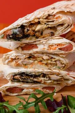 Three types of sliced shawarma stacked on top of each other, red background a 스톡 사진