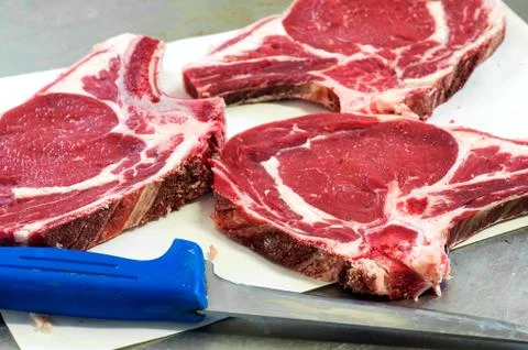 Three uncooked meat slices Stock Photos
