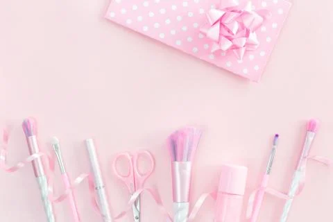 Three unicorn makeup brushes on silver violet Stock Photos
