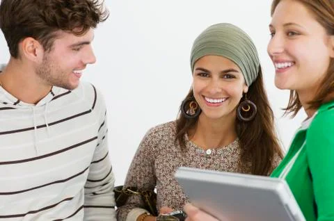 Three university students standing together and smiling Stock Photos