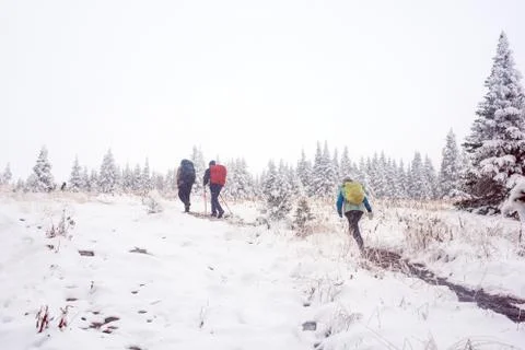 Three unknown climb the mountain Stock Photos