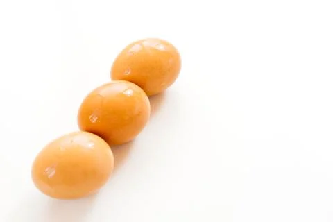 Three unpainted eggs on white background. Food and easter Stock Photos