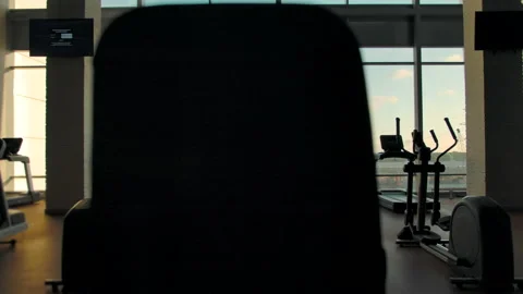 Three unrecognizable people running on treadmills in an empty gym Stock Footage 138609742