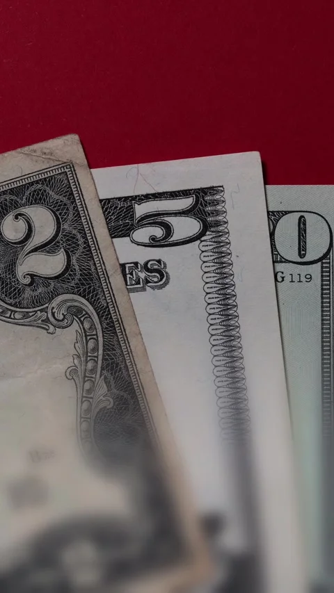 Three US dollar bills layered to form number 250 on a red background. Financial Stock Footage 337422319