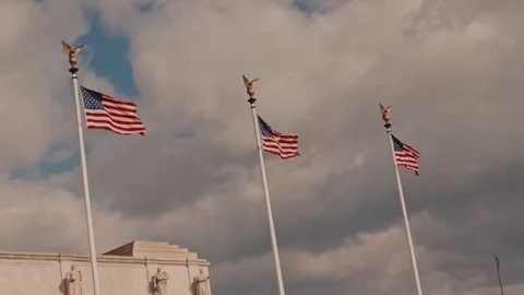 Three US Flags Waving on Flagpoles Against Cloudy Sky Stock Footage 337513592