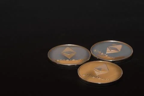 Three valueable silver ether coins from cryptocurrency on black Stock Photos