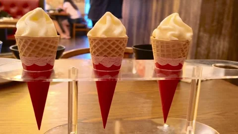 Three vanilla ice cream cones served in a tray holder in a restaurant. Smoo.. Video stock 318248205