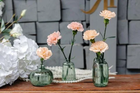 Three vases with flowers on a table Foto stock