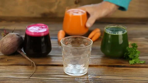 Three vegetable juice in glass cup on wooden background Stock Footage 101824767