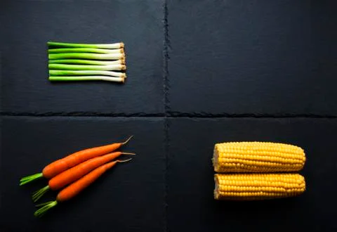 Three vegetables on slate base Stock Photos