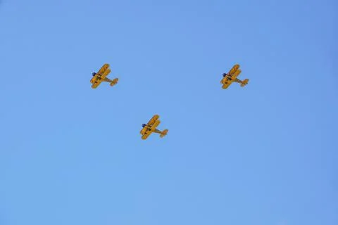Three vintage airplane in flight . at empty blue sky Stock Photos