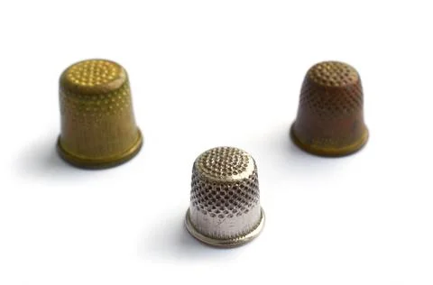 Three vintage thimbles isolated on a white background with shadow Illustrazione stock