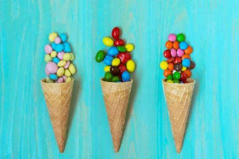 Three wafer cones with colored candy Stock Photos