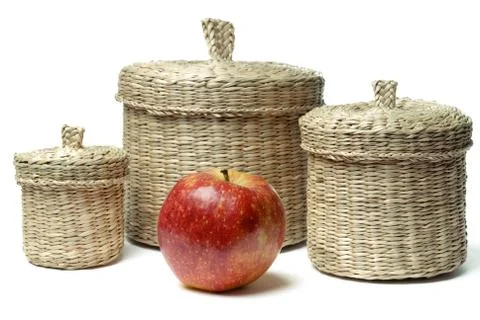 Three wattled baskets and apple isolated Stock Photos