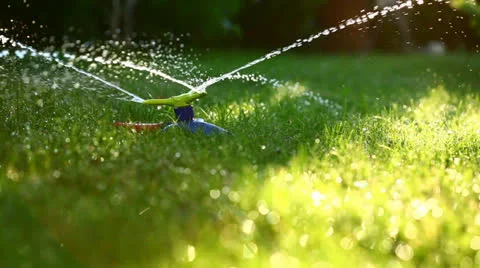 Three-way sprinkler in garden Stock Footage 26174528