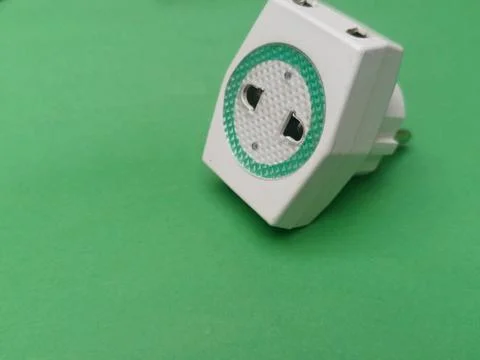 Three Way T Shaped Multi Plug Socket Adapter On Green Background Stock Photos