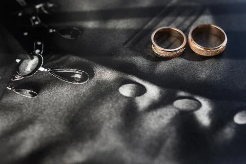 Three wedding ring on a black background Stock Photos