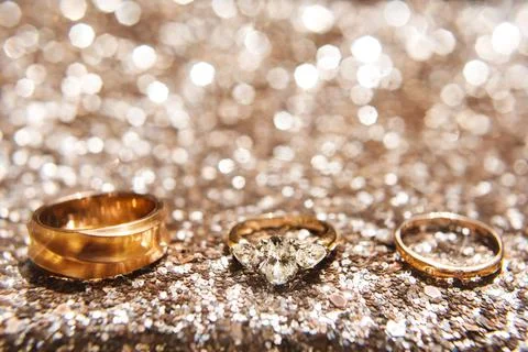 Three wedding ring on a shiny background Stock Photos