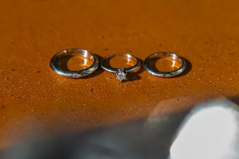 Three wedding rings on a brown background Stock-Fotos