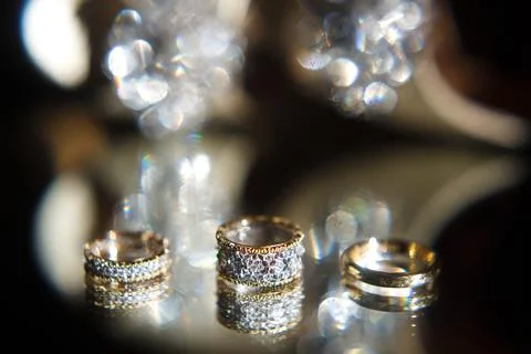 Three wedding rings on a mirror Stock Photos