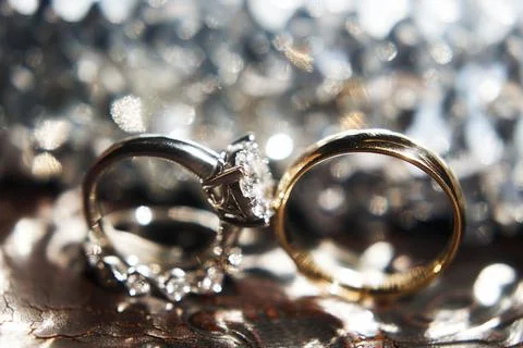 Three wedding rings on the reflecting surface with highlights Stock Photos