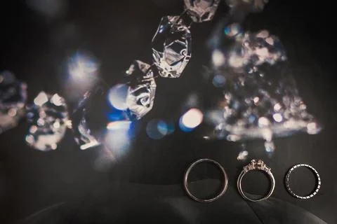 Three wedding rings on a shiny background Stock Photos