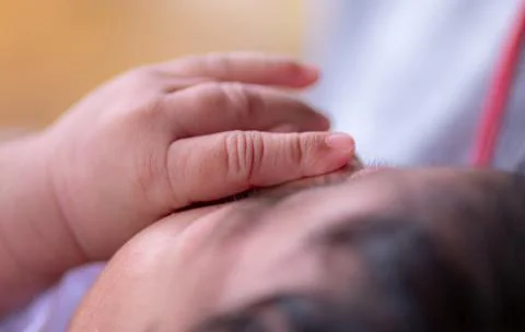 Three weeks old adorable infant baby girl's hand on her face, sleeping cute s Stock Photos