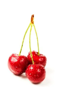 Three wet cherries Stock Photos