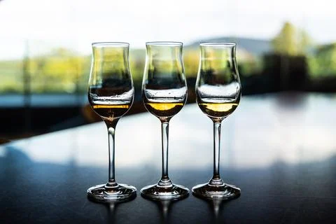 Three whiskey glasses containing single malt whiskey of different year and qu Stock Photos