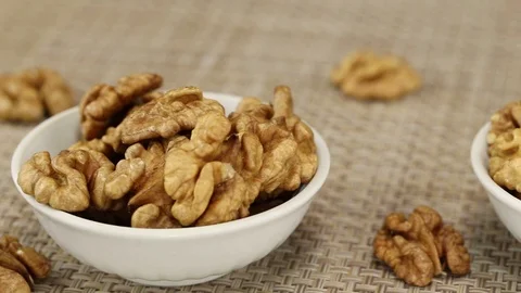 Three white bowls with walnuts Stock Footage 124046465