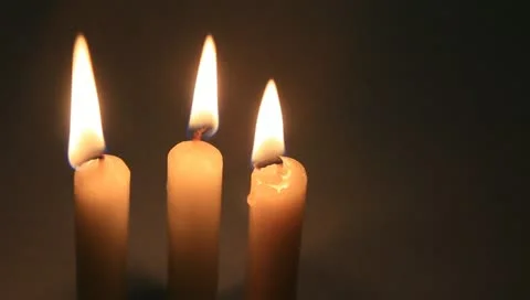 Three white candles on black Stock Footage 11022367
