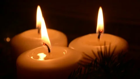 Three white candles burn in the dark Stock Footage 143719863