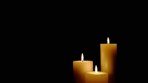 Three white candles burning. Isolated candles burning over dark background.Wh Stock Footage 149569971