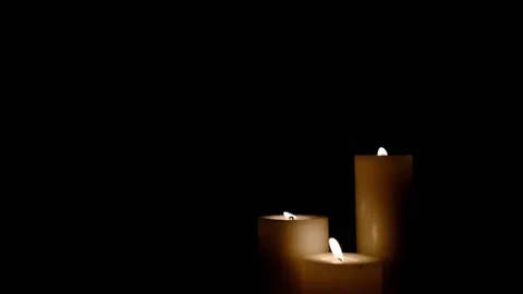 Three white candles burning. Isolated candles burning over dark background.Wh Stock Footage 149569981