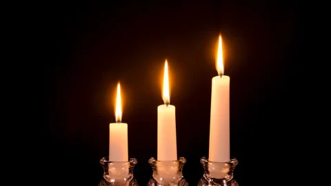 Three white candles burning out Stock Footage 128729870