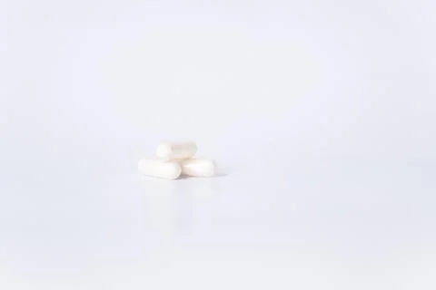 Three White Capsules on a White Background. There is space for text. Stock Photos
